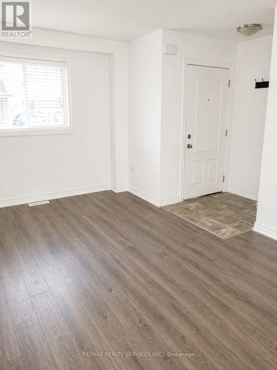 A room with a white door and a window with blinds.