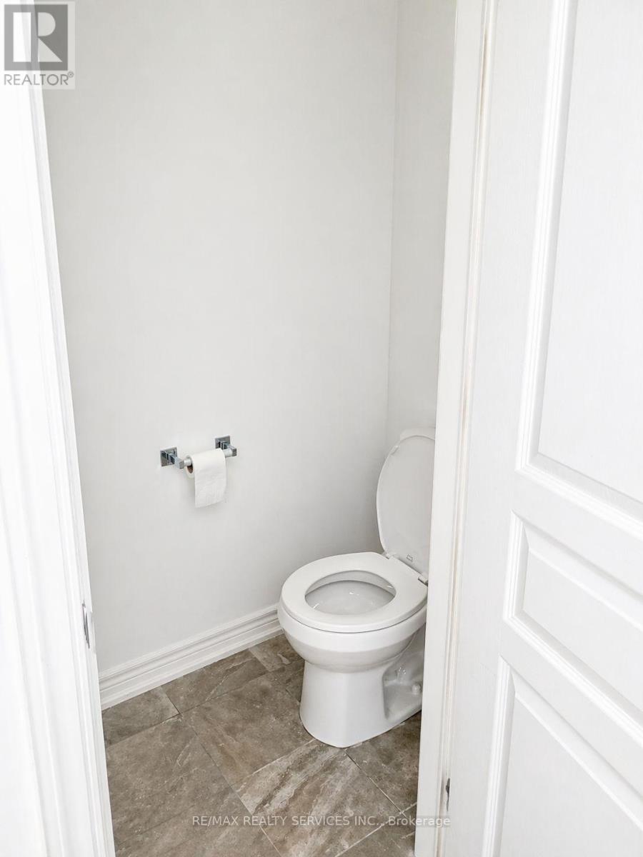 A white toilet in a small bathroom.