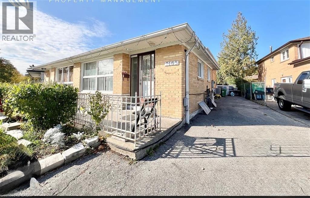 A house with a boarded up window is for sale.