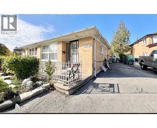 A house with a boarded up window is for sale.
