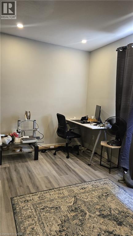 A room with a desk, chair, and computer setup.