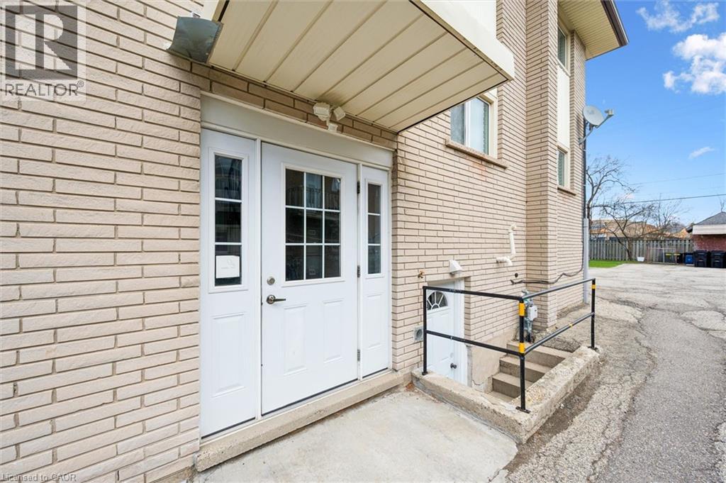 A house with a white door and a sign that says "REALTOR" on the wall.
