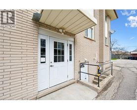 A house with a white door and a sign that says "REALTOR" on the wall.