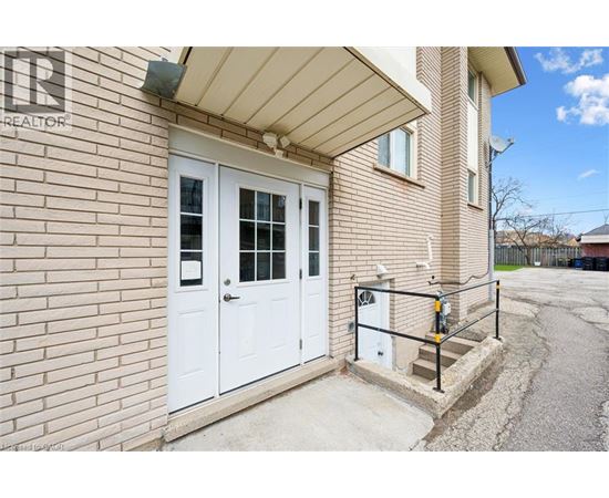 A house with a white door and a sign that says "REALTOR" on the wall.