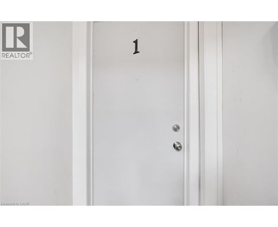 A white door with a number 1 on it.