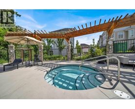 A hot tub sits in the middle of a patio area.