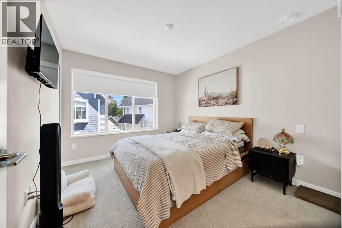 A bedroom with a large bed and a television on the left side.