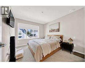 A bedroom with a large bed and a television on the left side.