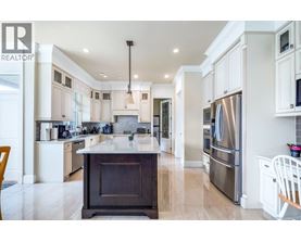 A modern kitchen with a large island and stainless steel appliances.