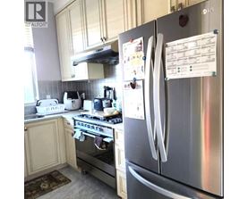 A kitchen with a stove, oven, and refrigerator.