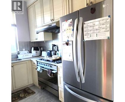 A kitchen with a stove, oven, and refrigerator.