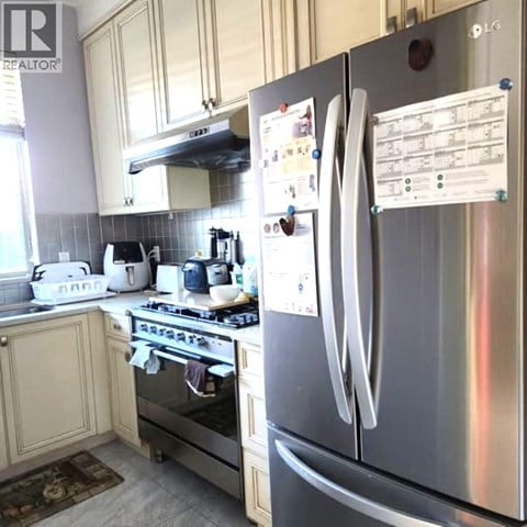A kitchen with a stove, oven, and refrigerator.