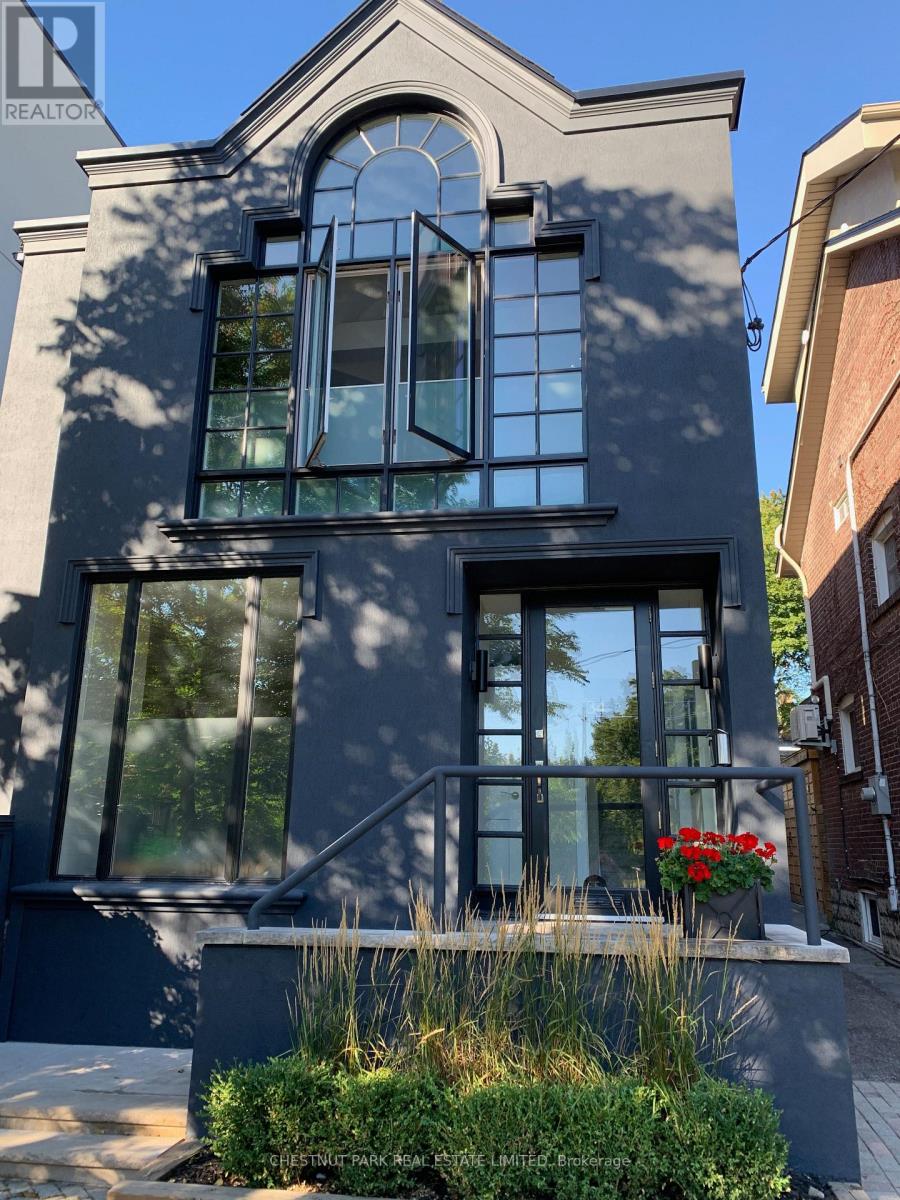 A house with a large window and a balcony.