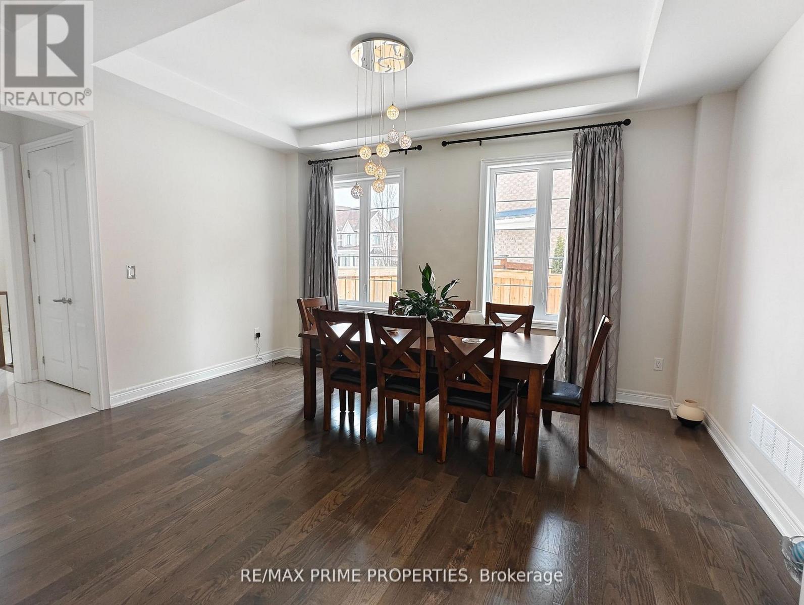 A dining room with a table set for six.