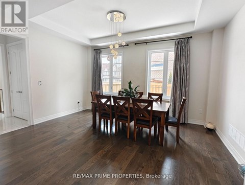 A dining room with a table set for six.