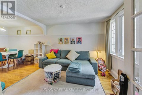A living room with a grey couch and a white coffee table.