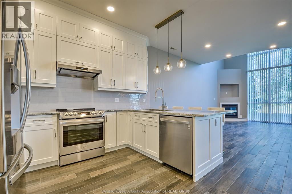 A kitchen with white cabinets and stainless steel appliances.