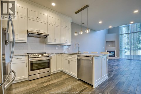 A kitchen with white cabinets and stainless steel appliances.