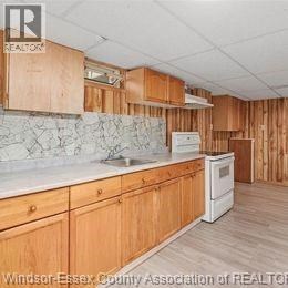 A kitchen with wooden cabinets and a white countertop.