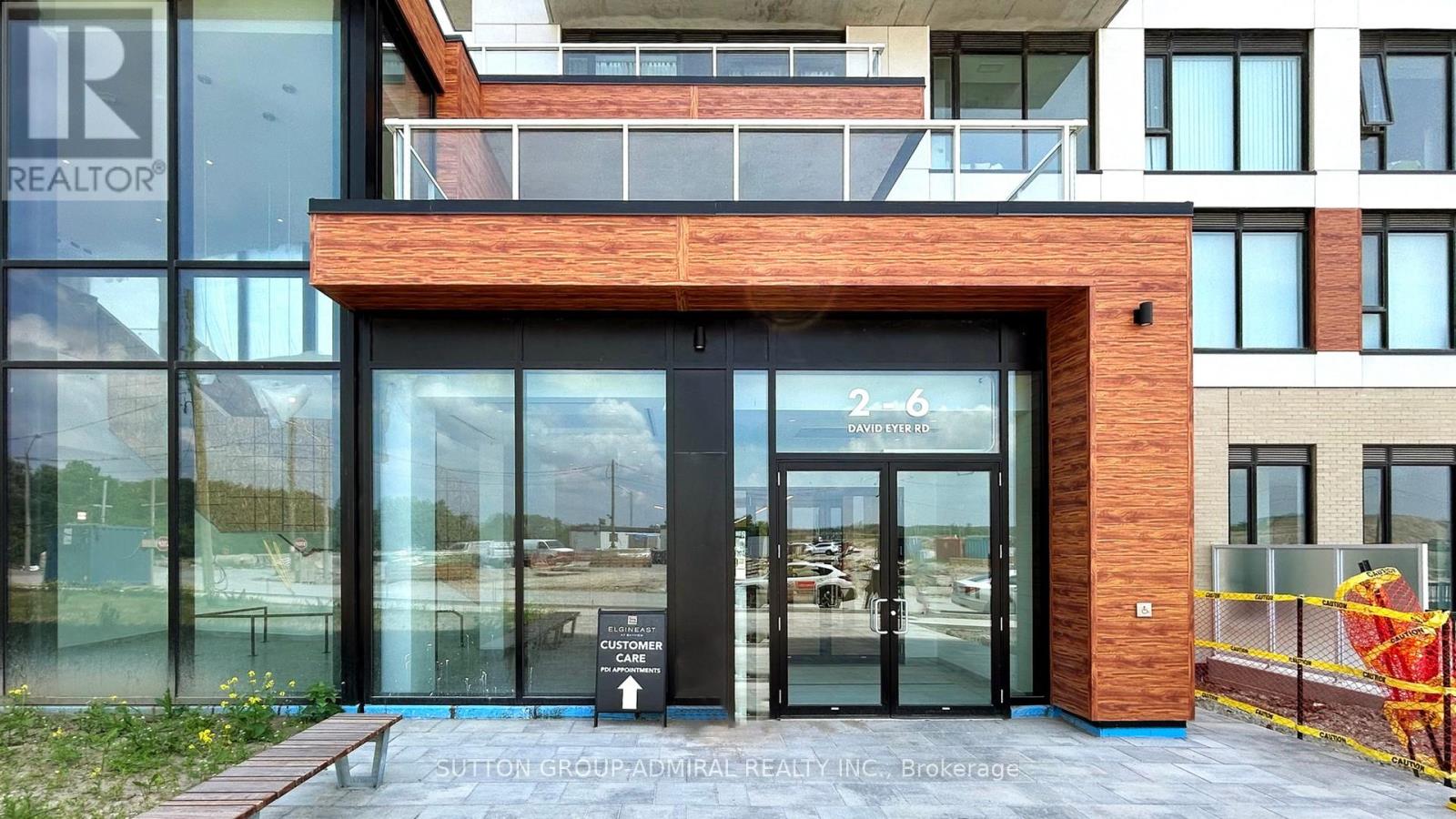 The entrance to a building with a glass door and a sign that reads "REALTOR".