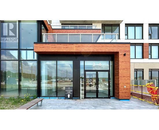 The entrance to a building with a glass door and a sign that reads "REALTOR".