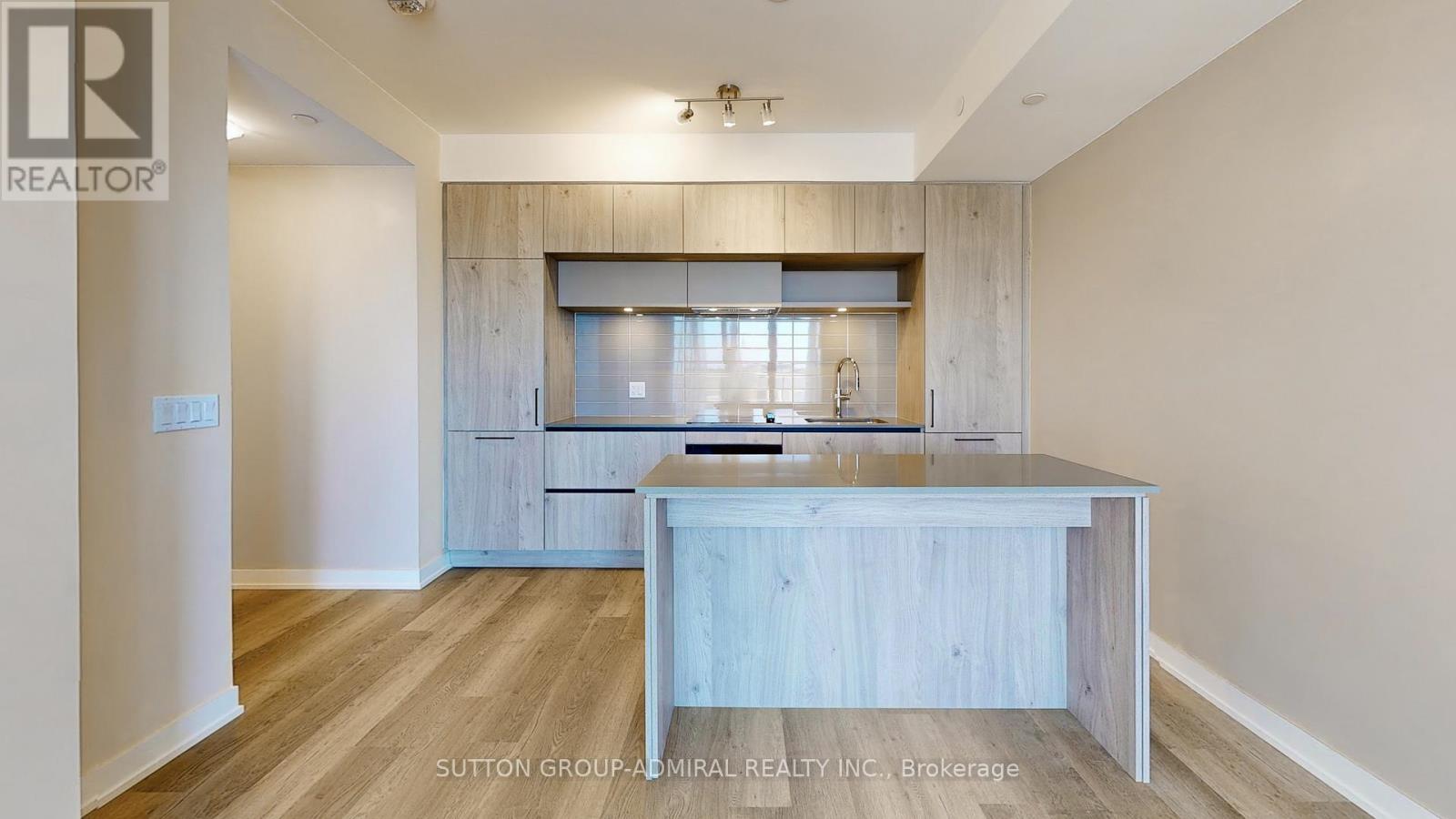 A kitchen with a wooden island and a window above it.