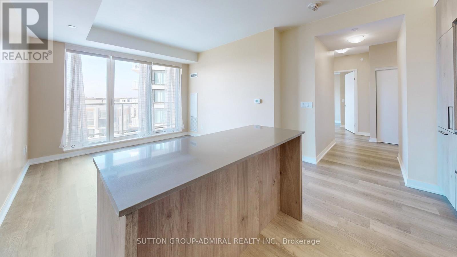 A spacious room with a long counter and a window overlooking a cityscape.