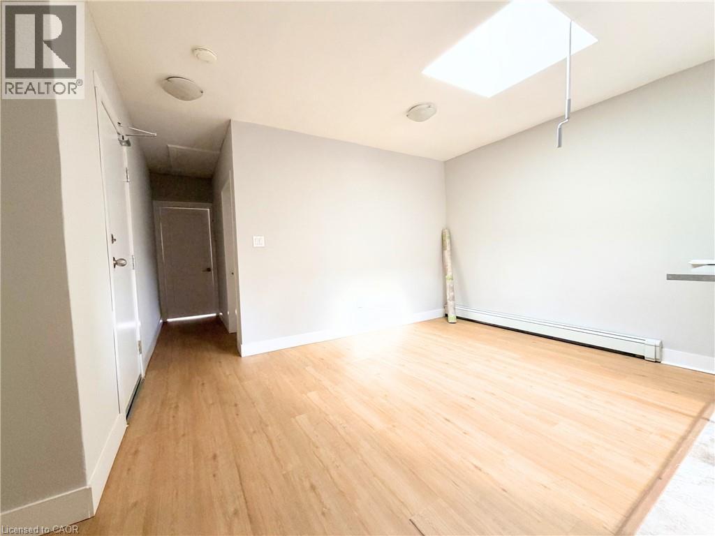 A room with wooden flooring and a skylight.