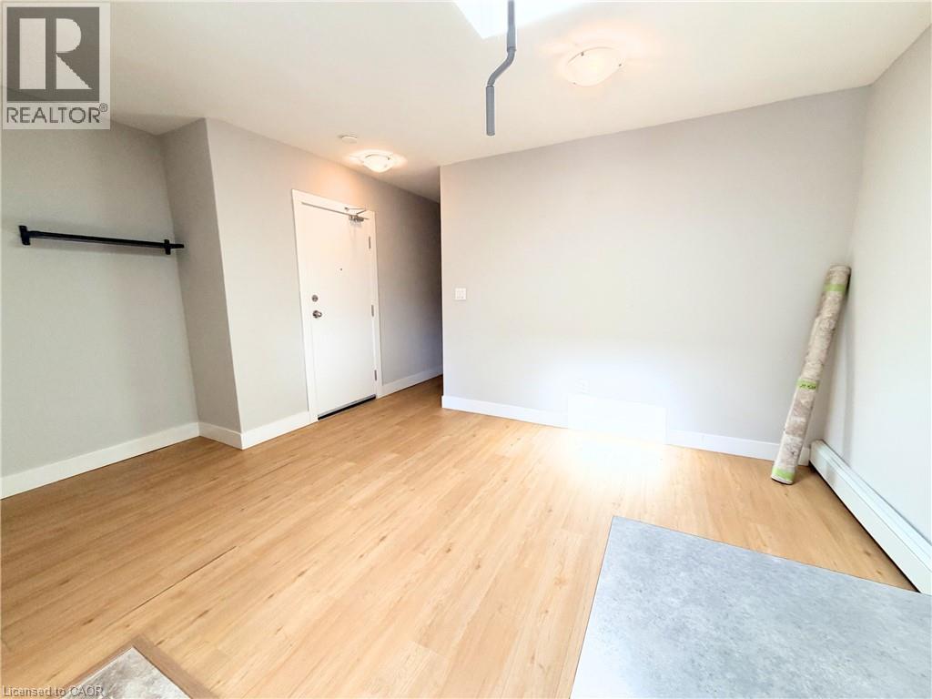 A room with wooden flooring and a white door.