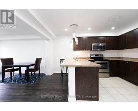 A modern kitchen with dark wood cabinets and a white island.