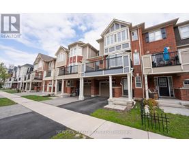 A row of townhouses with balconies and a sign that says Newgen Realty Experts Brokerage.