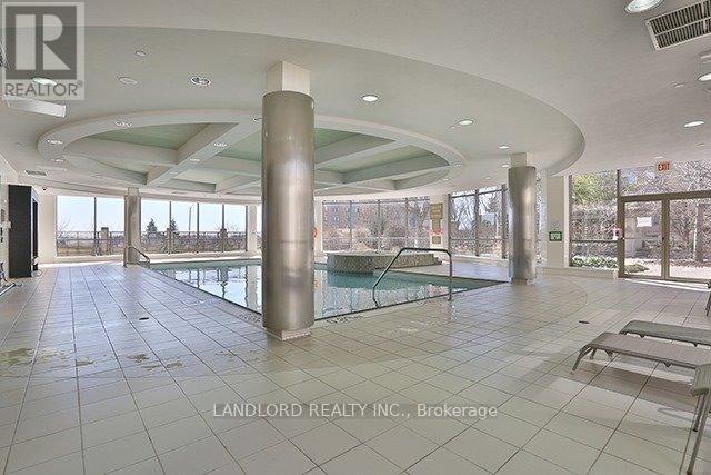 A large, empty indoor space with a pool table and a sunny view outside.