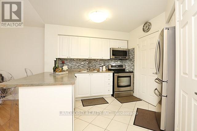 A kitchen with white cabinets and a granite counter top.