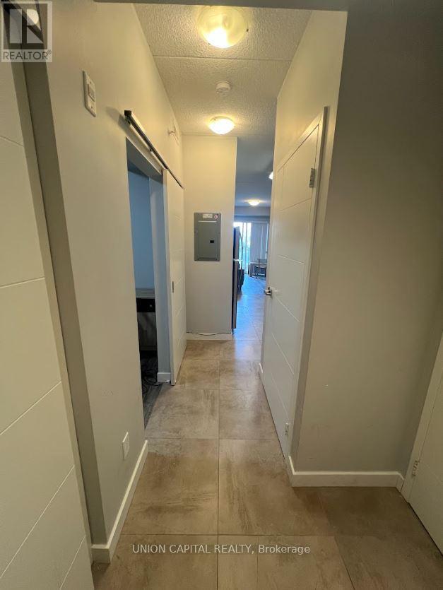 A hallway with a door on the left and a door on the right.