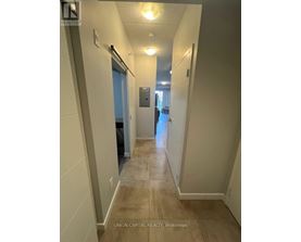 A hallway with a door on the left and a door on the right.
