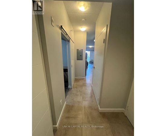 A hallway with a door on the left and a door on the right.