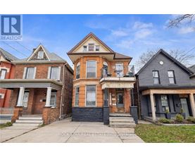 Three houses are shown in the image, with the middle one being the most prominent.