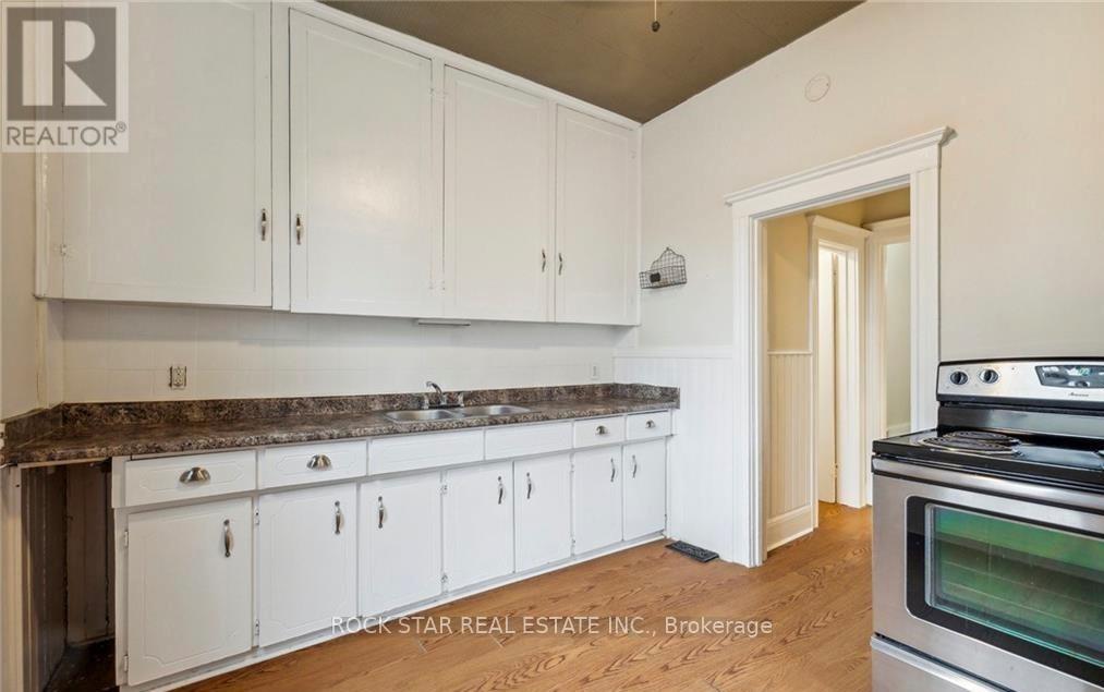 A kitchen with white cabinets and a granite countertop.