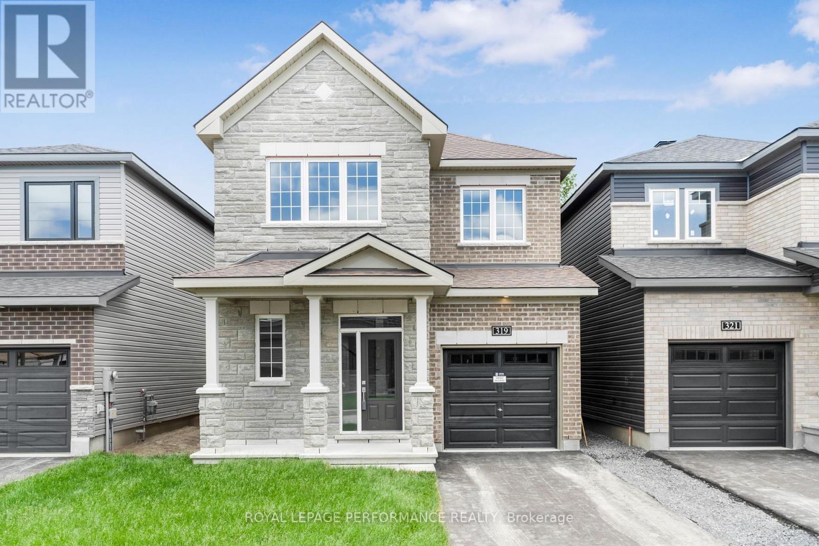 A house with a grey roof and a garage door is shown.