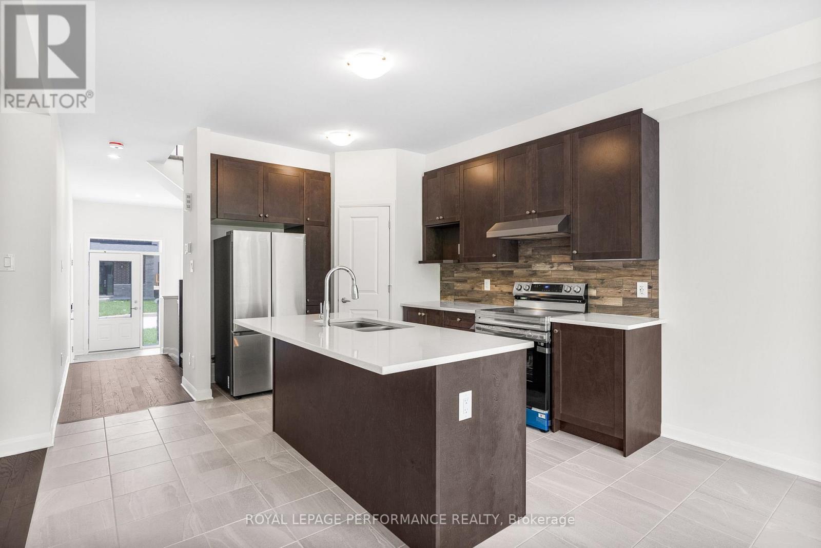 A kitchen with brown cabinets and a white counter.