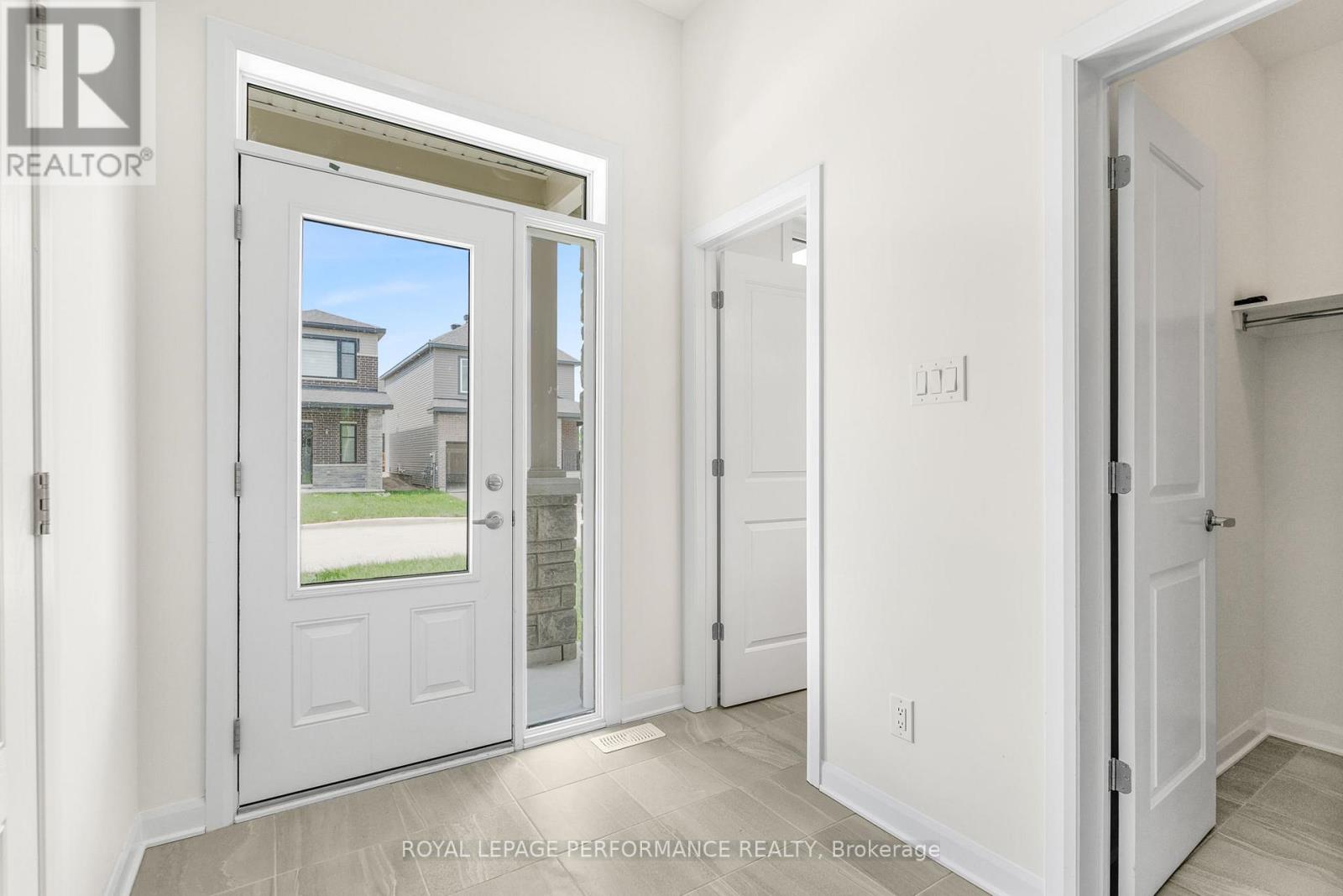 A white door with a glass window is open.