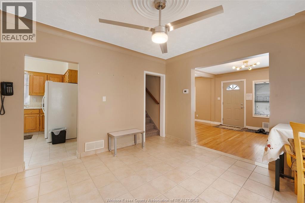 A spacious room with a ceiling fan and a table.