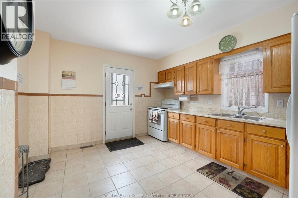 A kitchen with wooden cabinets and a white door.