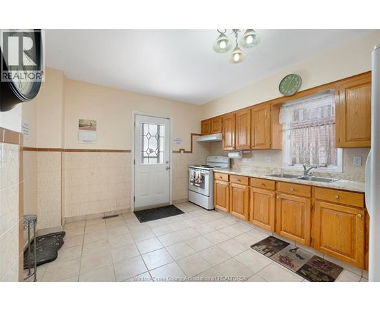 A kitchen with wooden cabinets and a white door.
