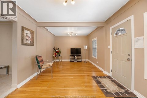 A living room with a television and a chair.