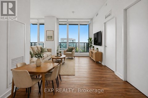 A well-lit, spacious living room with a dining table and chairs.