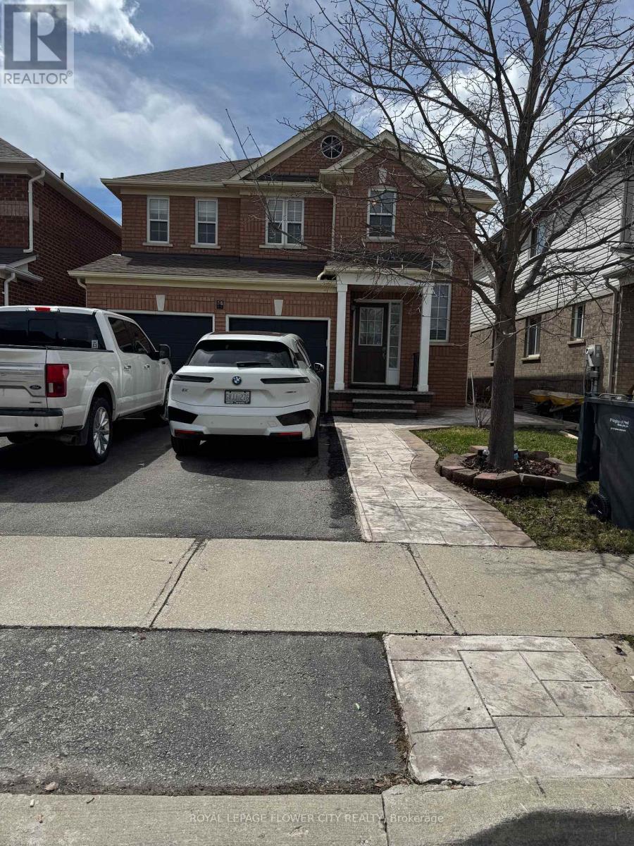 A white car is parked in front of a house.