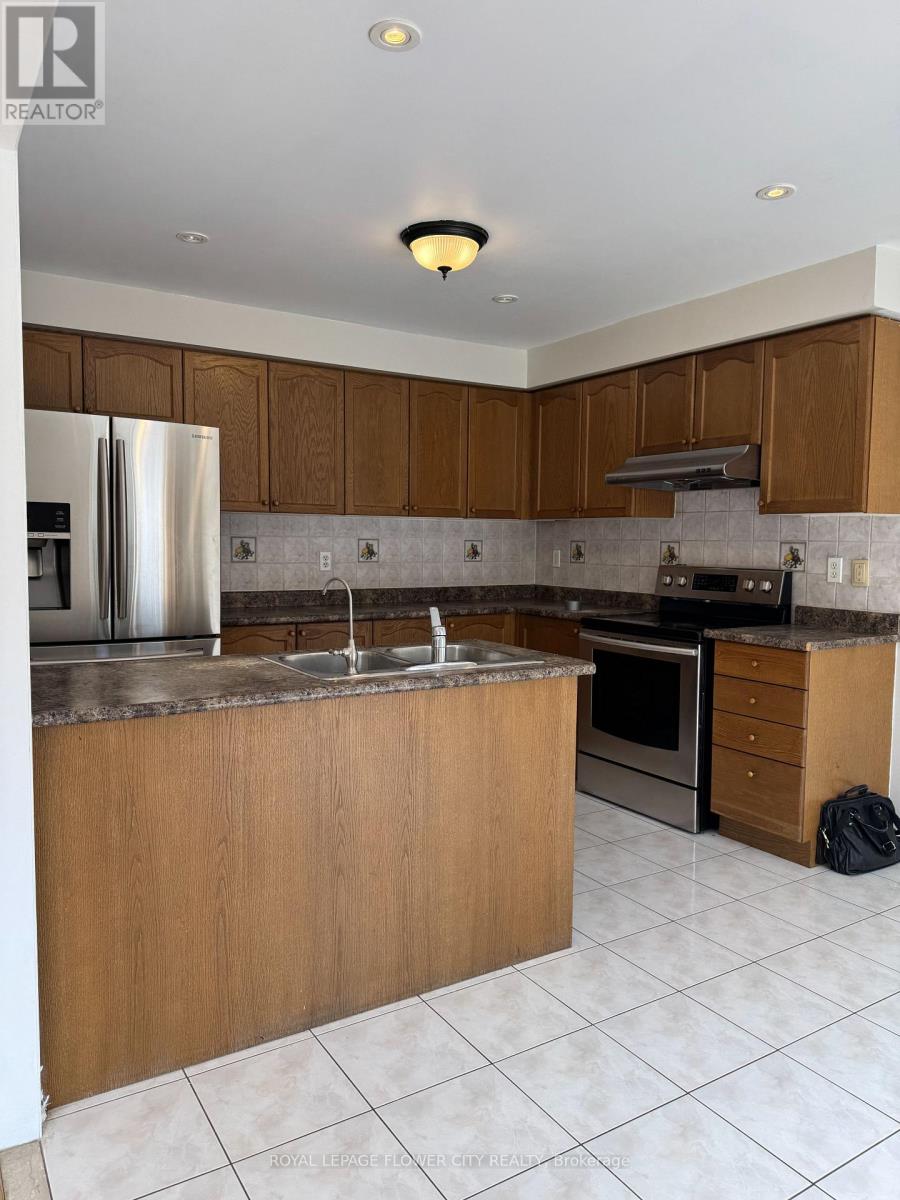 A kitchen with wooden cabinets and a refrigerator.