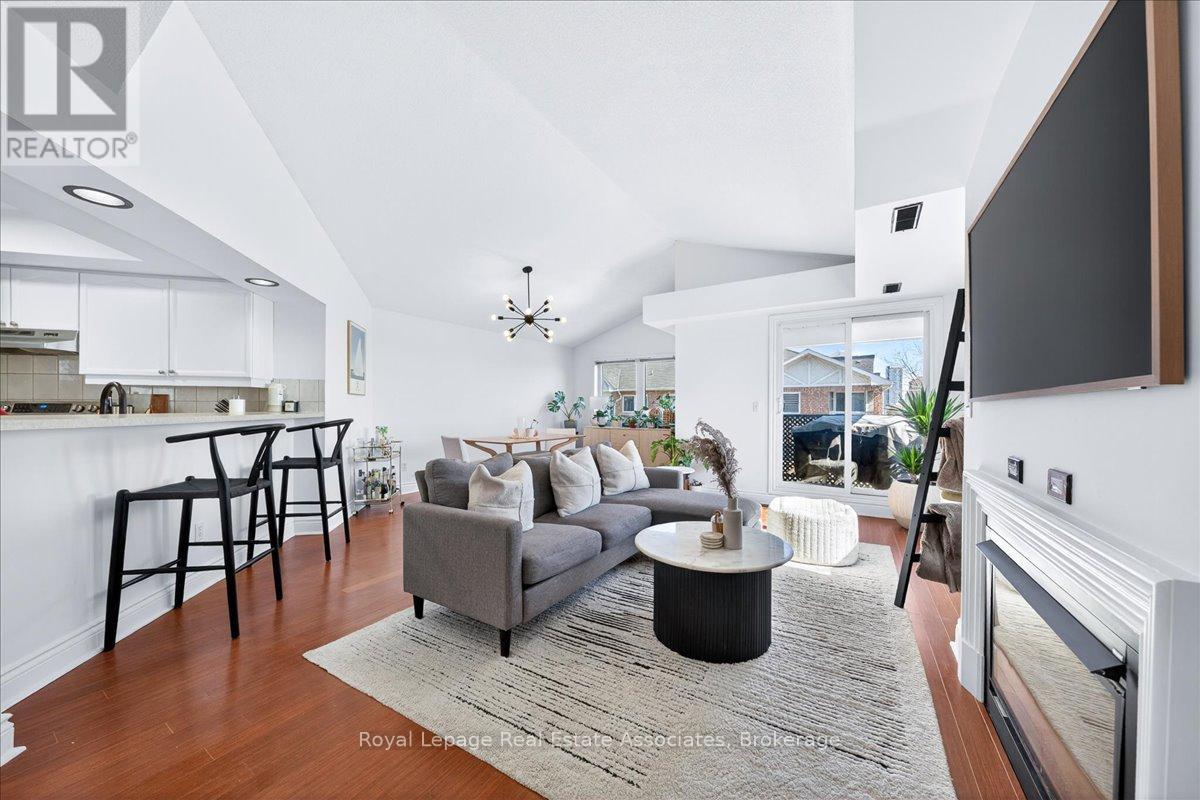 A living room with a grey couch and a black coffee table.