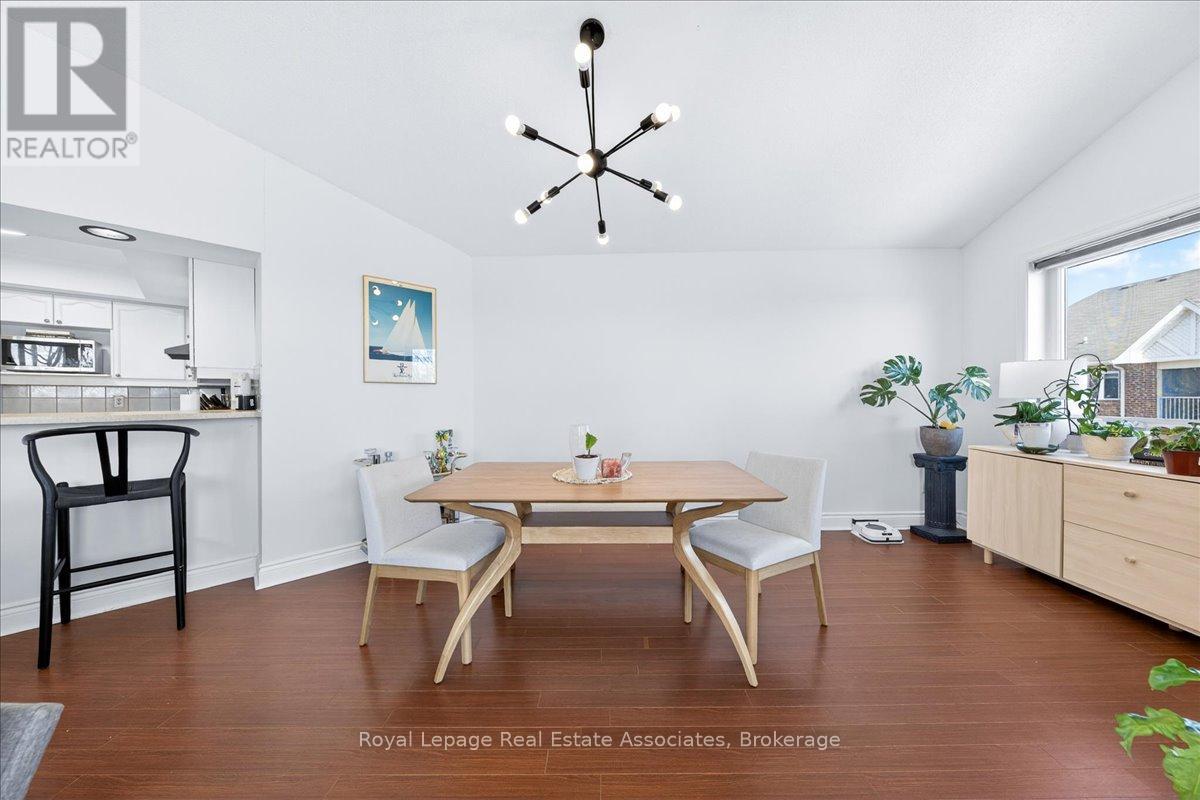 A dining room with a table and chairs.